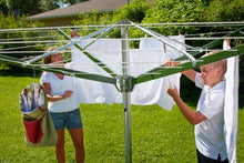 Load image into Gallery viewer, Mom and son hanging clothes on a Deluxe DS9 Sunshine Clothesline